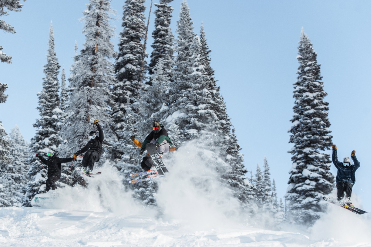 A group of skiers ride down a mountain