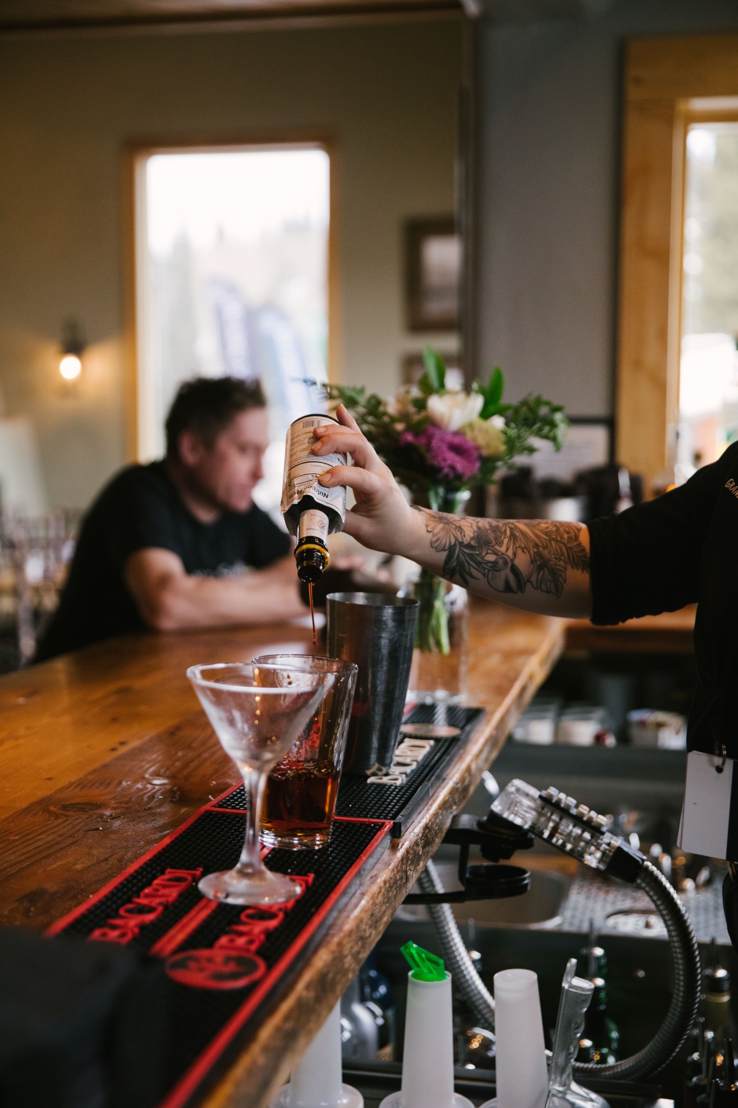 A man pouring a drink at a bar