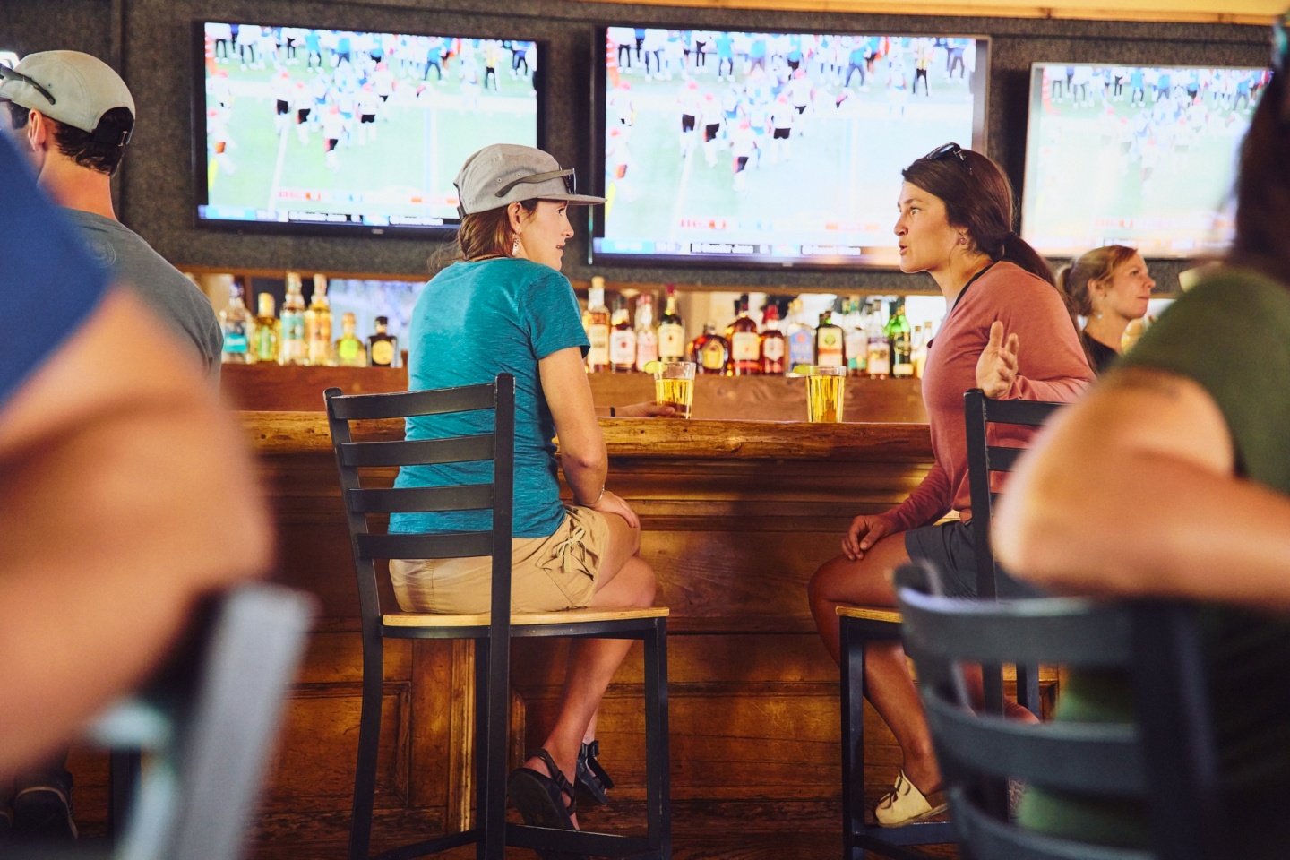 Two friends enjoying drinks at a bar