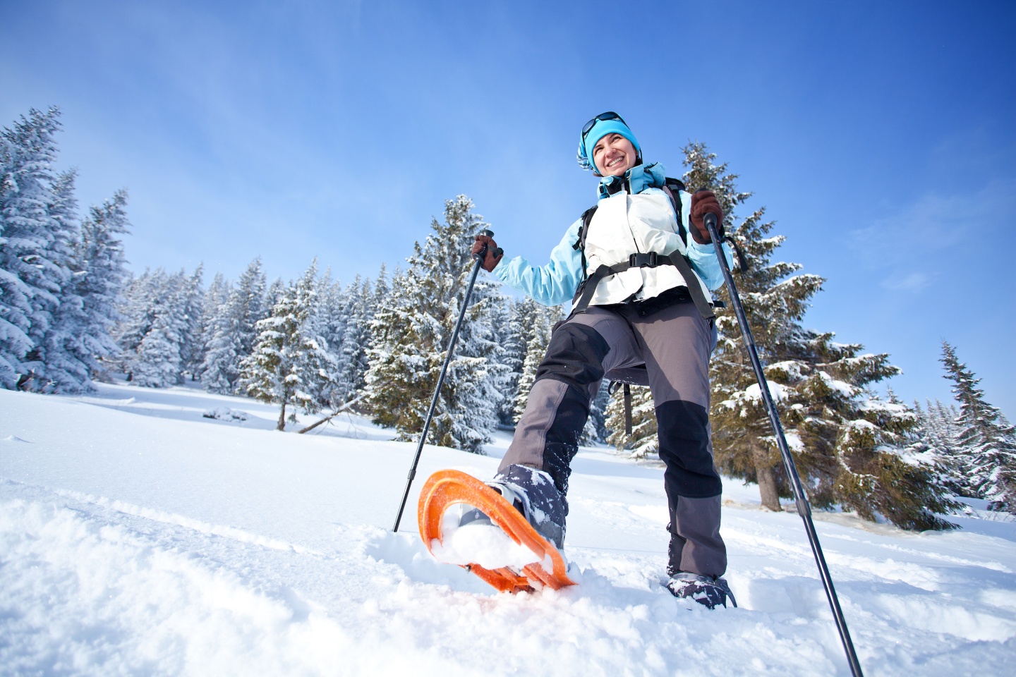 Woman snowshoeing in woods