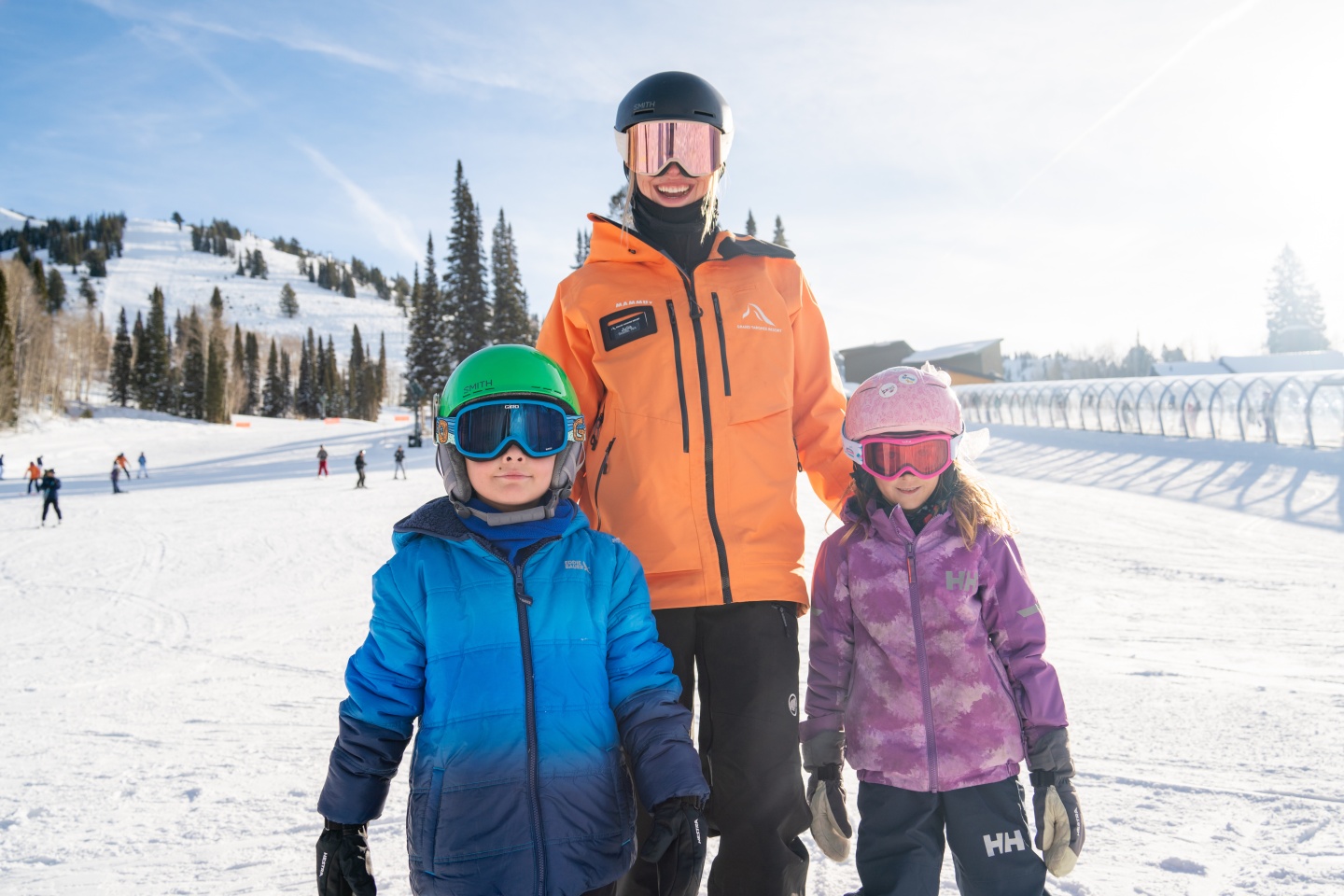 Ski School instructor with two junior skiers